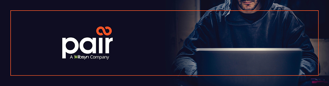 Man in a hooded jacket looking down at laptop amidst sinister lighting. Pair logo on the left.