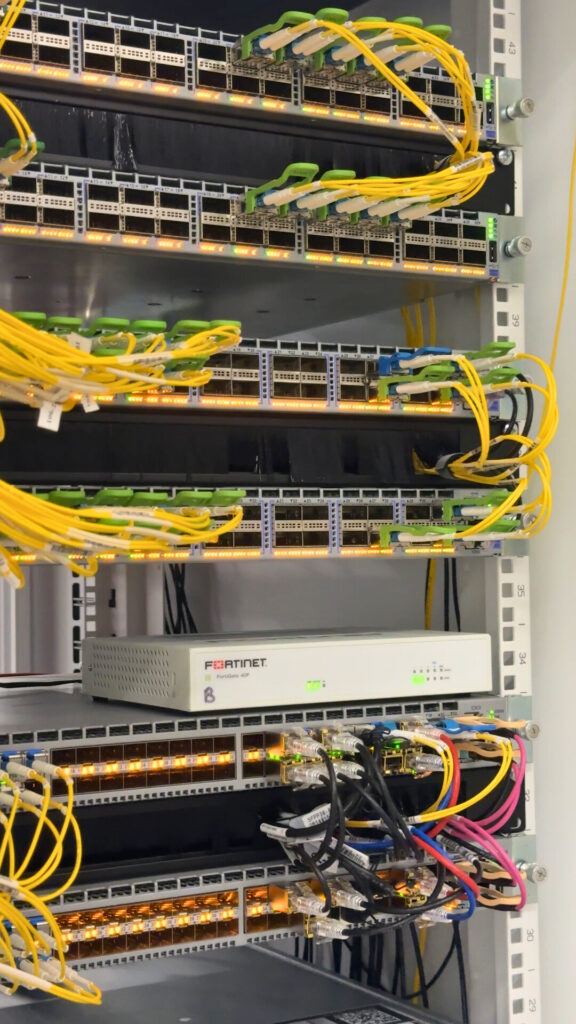 image of a server rack with many bunches of yellow, red, and green wires